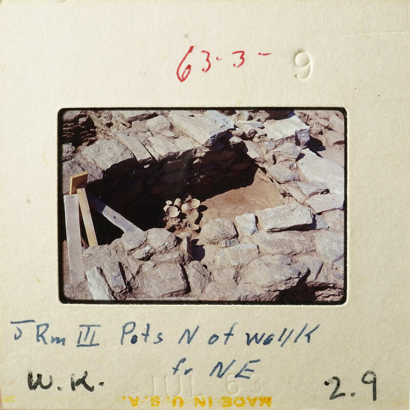 This is an old photograph showing ruins with exposed stone and dirt, possibly from an archaeological site.