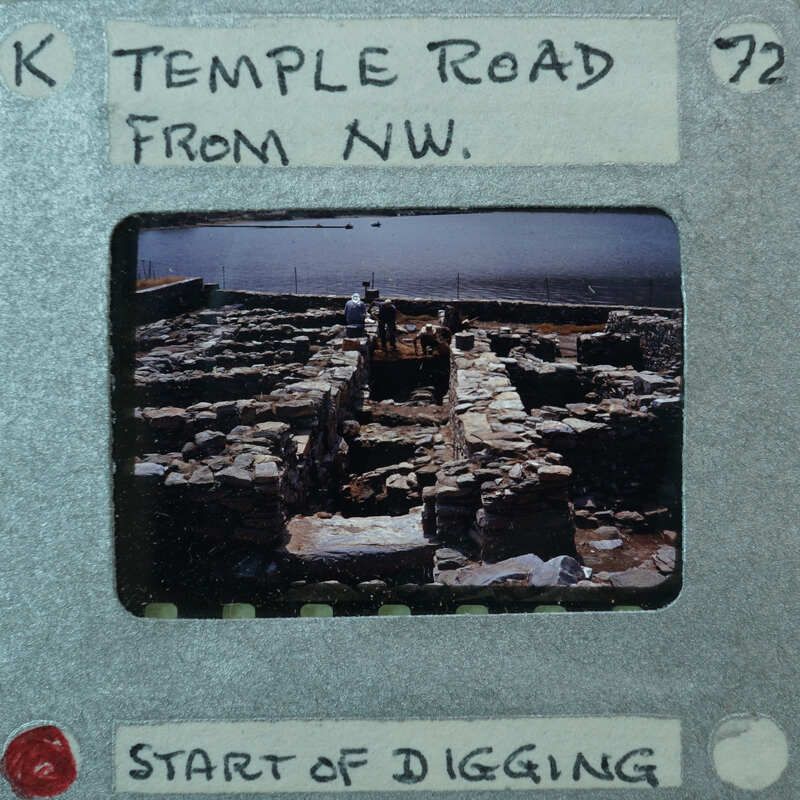 Parallel wall with surface between them and water in the background.