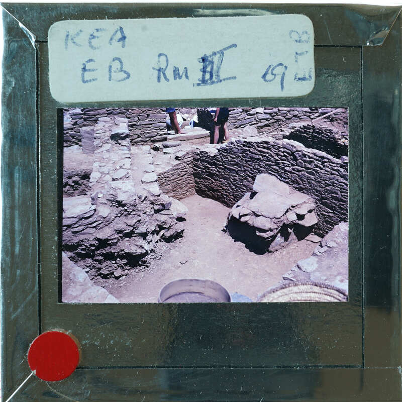 Excavated stone walls in various directions forming rooms.