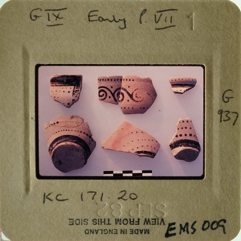 A collection of ancient pottery shards with intricate designs on them.