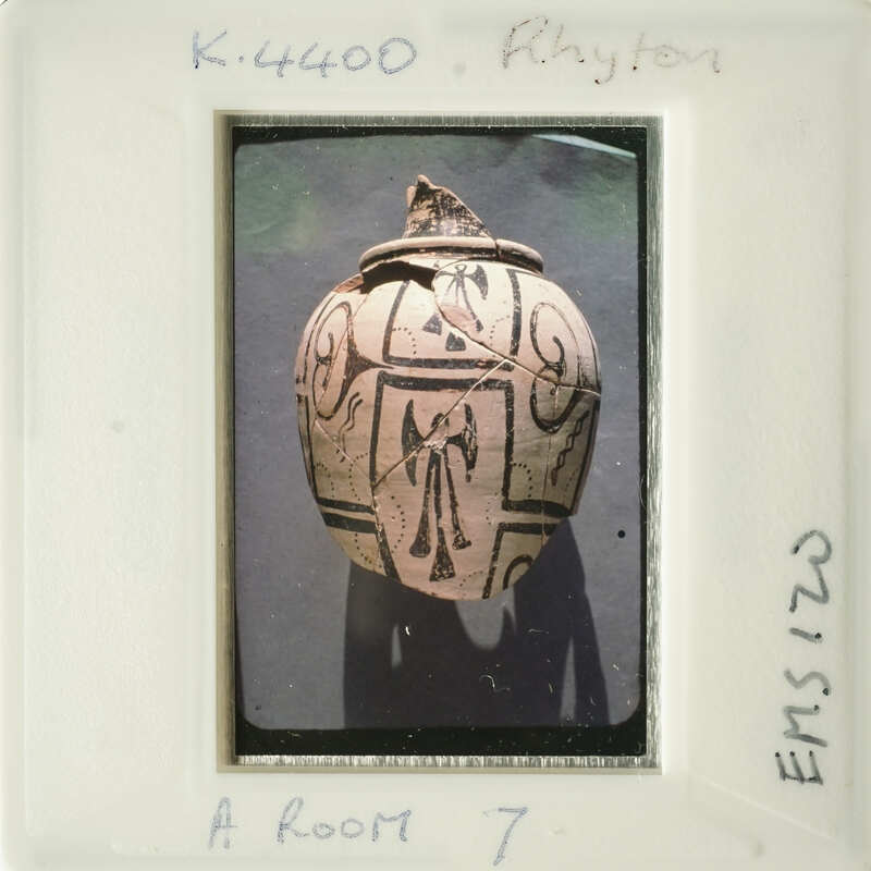 Ancient vase with intricate design on display.