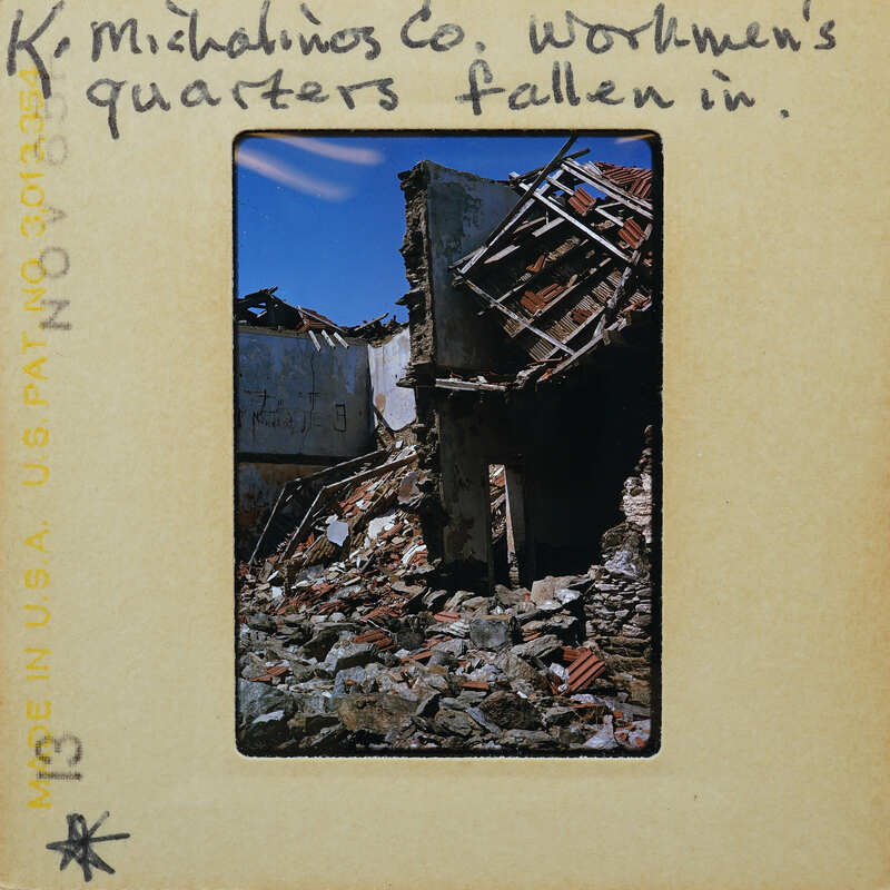 Photograph of a destroyed building with rubble and debris.