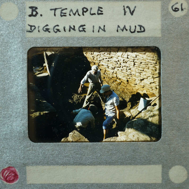 A slide of an archaeological site with ruins and workers, labeled as "Temple Room VI."