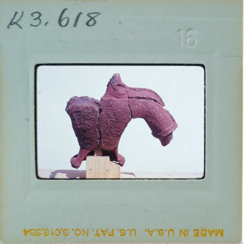 Terracotta figurine torso from back.