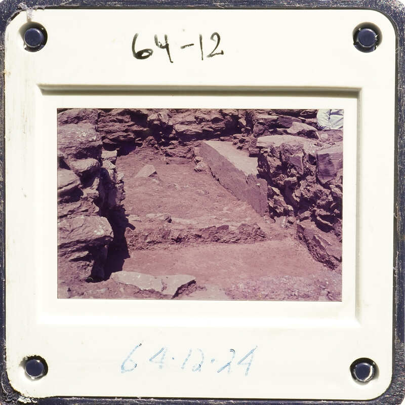A photograph showing an excavation site with exposed layers and rock formations, possibly from an archaeological dig.