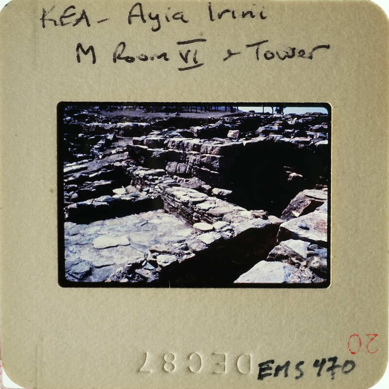 Ruined stone structure with vegetation, possibly part of an ancient city.