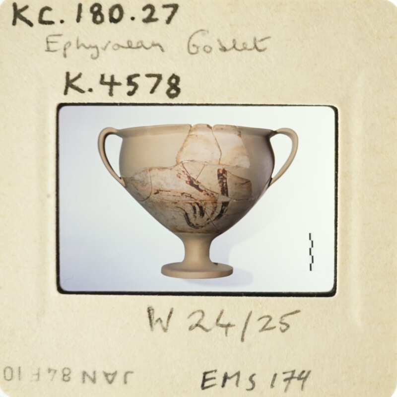 Ancient Greek cup with painted scenes, photographed on a white background.