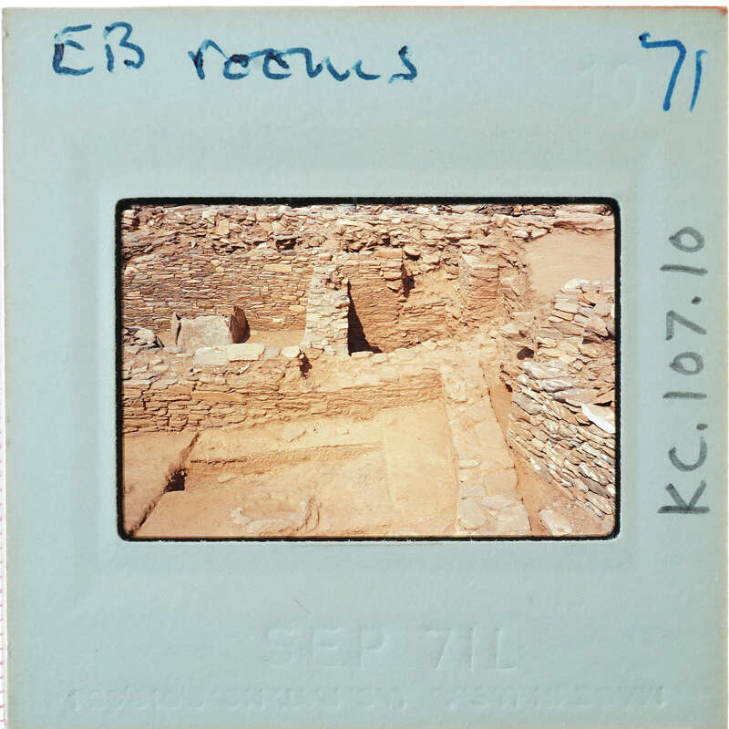 Excavated stone walls in various directions forming rooms.