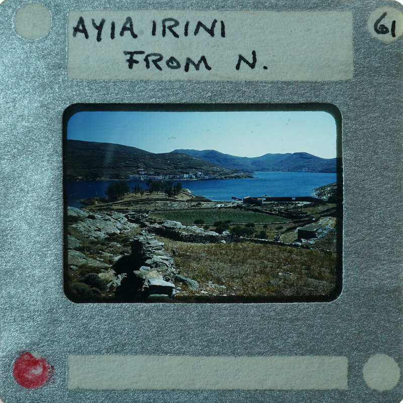 Picture of a landscape with mountains, water, and vegetation on an old film strip.