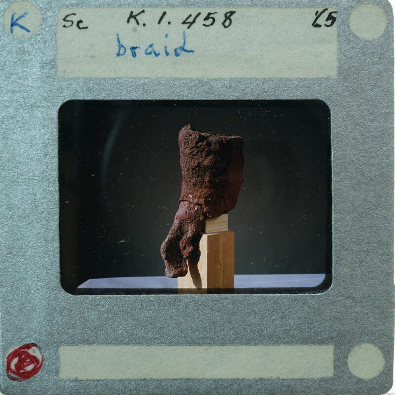 Terracotta figurine hair braid from 3/4 view K1.458.