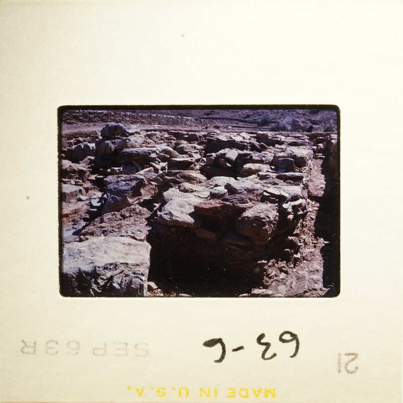 This is an image of historical ruins, possibly ancient walls and structures, with a focus on the texture and erosion of the stone materials.