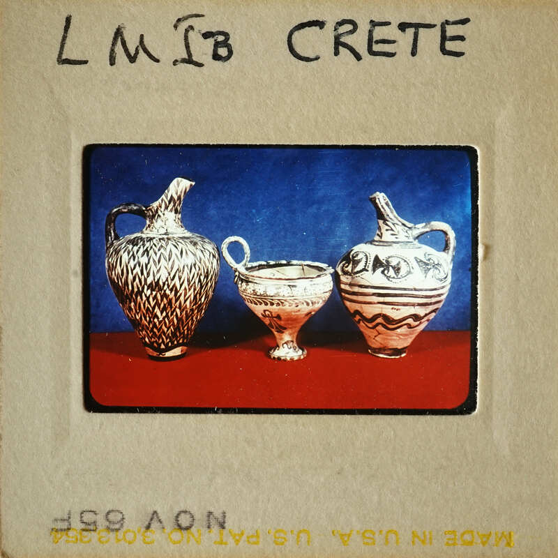 Three vases on display, with two larger ones and one smaller cup-like vessel.