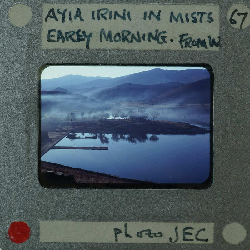 Photo of a misty landscape with mountains and water, displayed on an old-fashioned film strip.