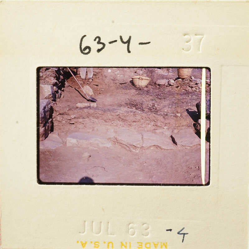 A photograph showing an excavation site with rocks and dirt, possibly from an archaeological dig.