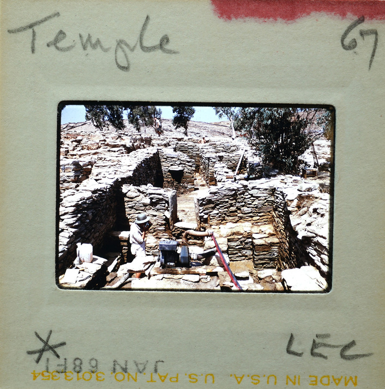 A photograph of an ancient stone temple with a visible film strip and numbers indicating its frame number.