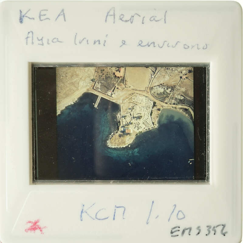 An aerial photograph of an island with coastline and buildings, labeled "KEA Air Aerial" and "Aegean Mini".