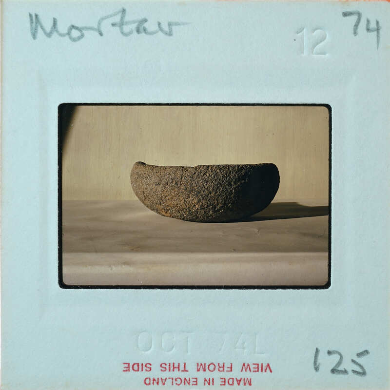 Profile of brown stone bowl on table.