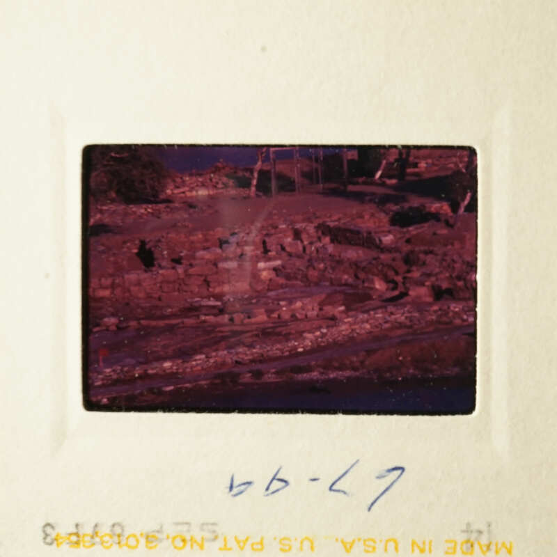The image shows a faded photograph of an ancient stone structure, possibly ruins, with a red tint and a date stamp indicating it was taken on 6/27/97.