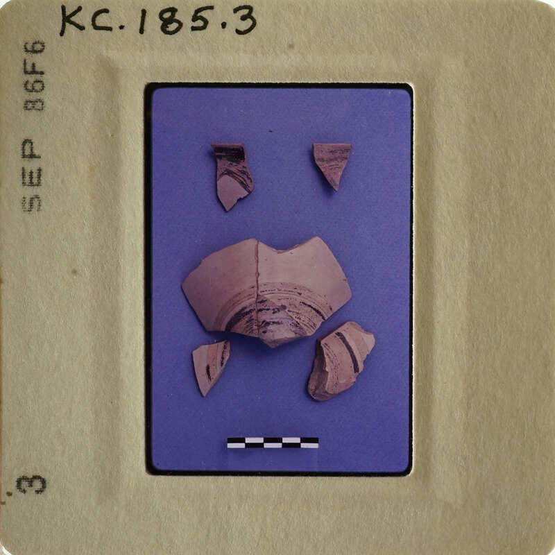 Small clay pottery fragments on blue background with white markings and labels.