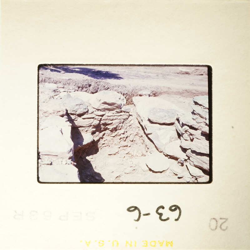 Ancient ruins with visible stone structures and shadows.