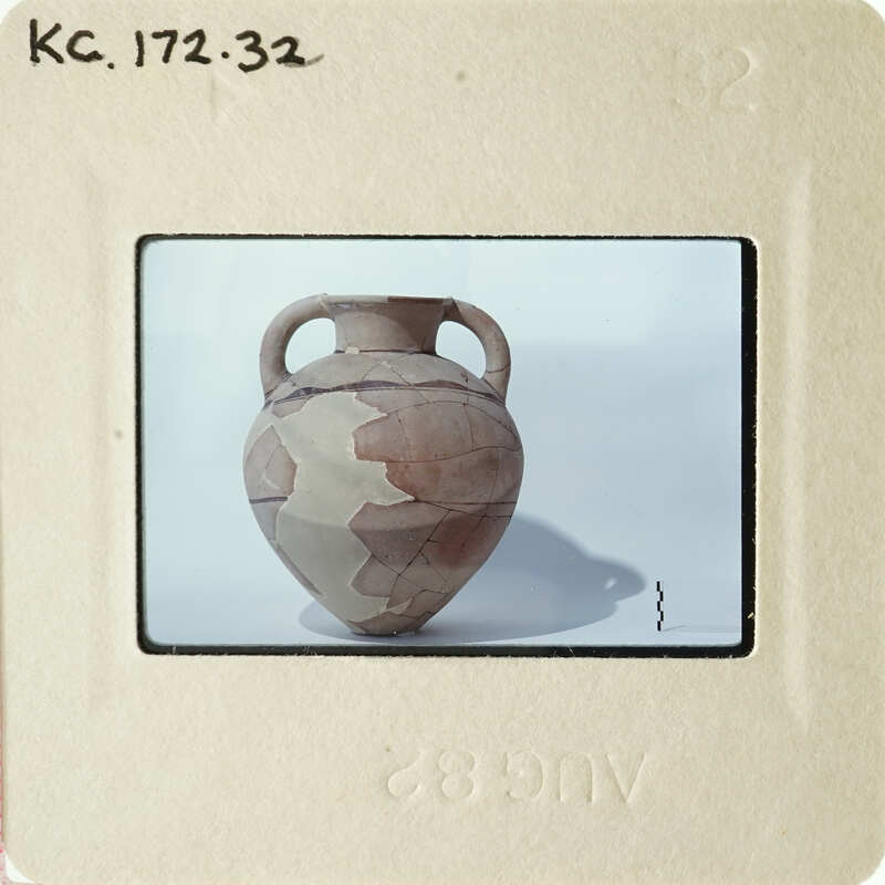 Ancient ceramic pot with earthy tones and visible cracks.