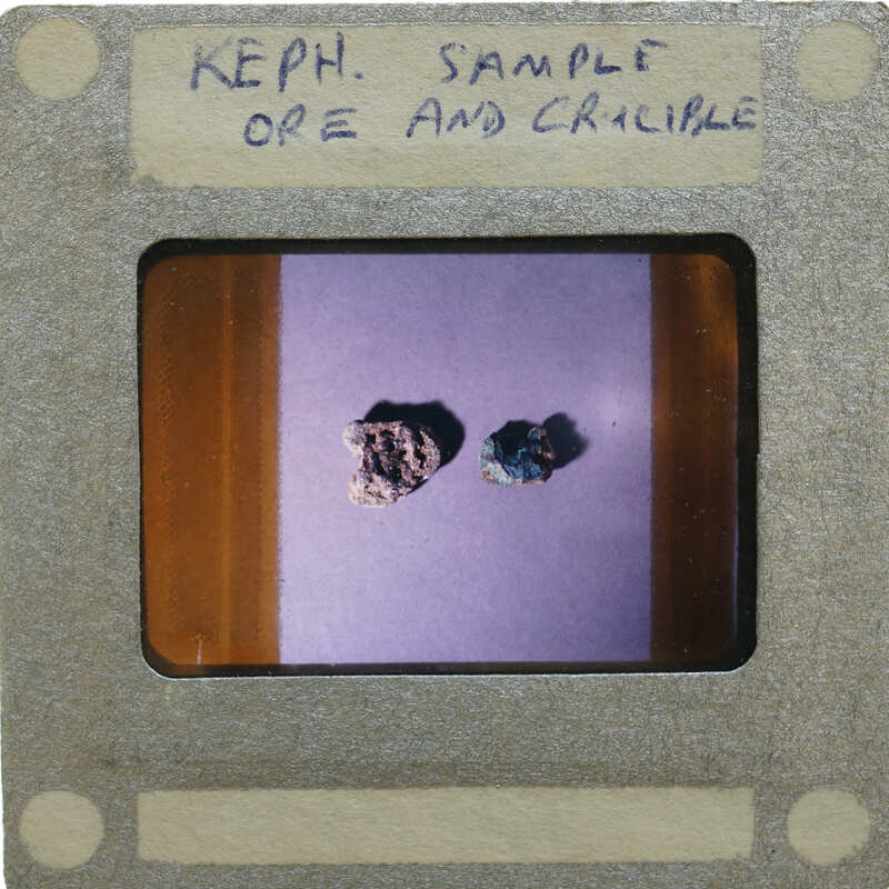 Two small rocks on a purple background with white writing.