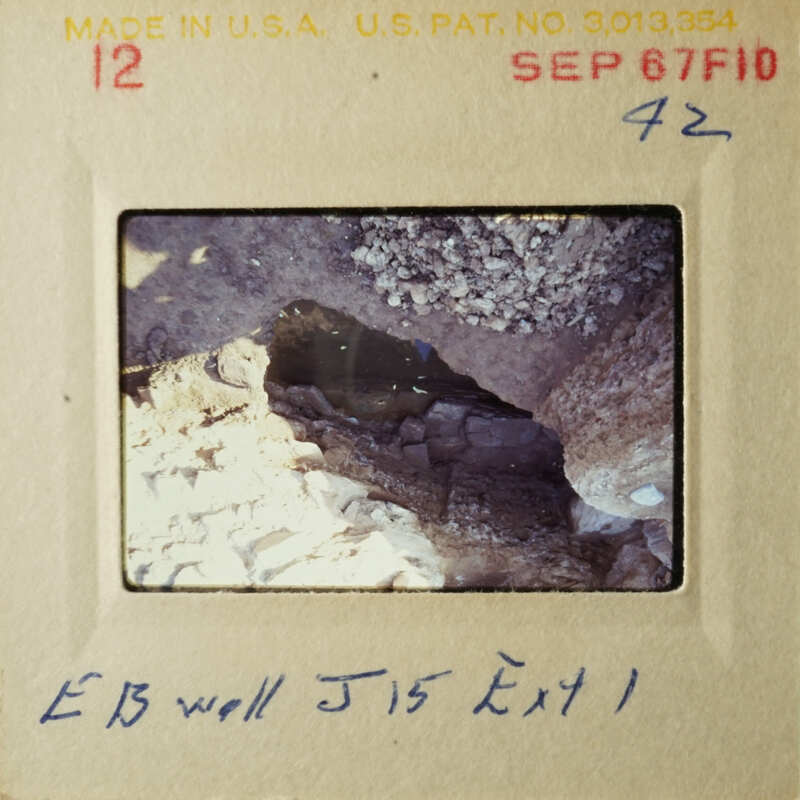 A photograph of an excavation site with handwritten notes.