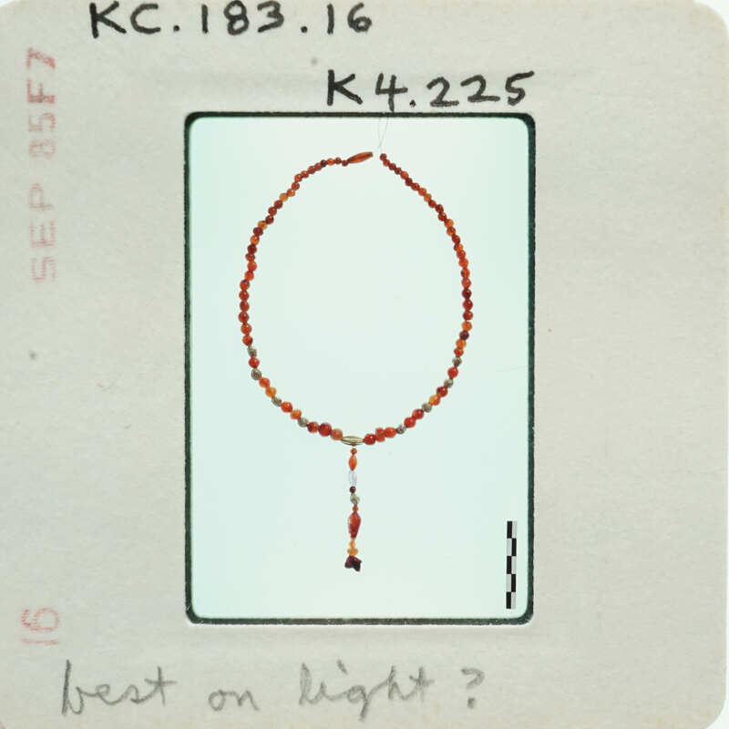 A bead necklace with a tassel.