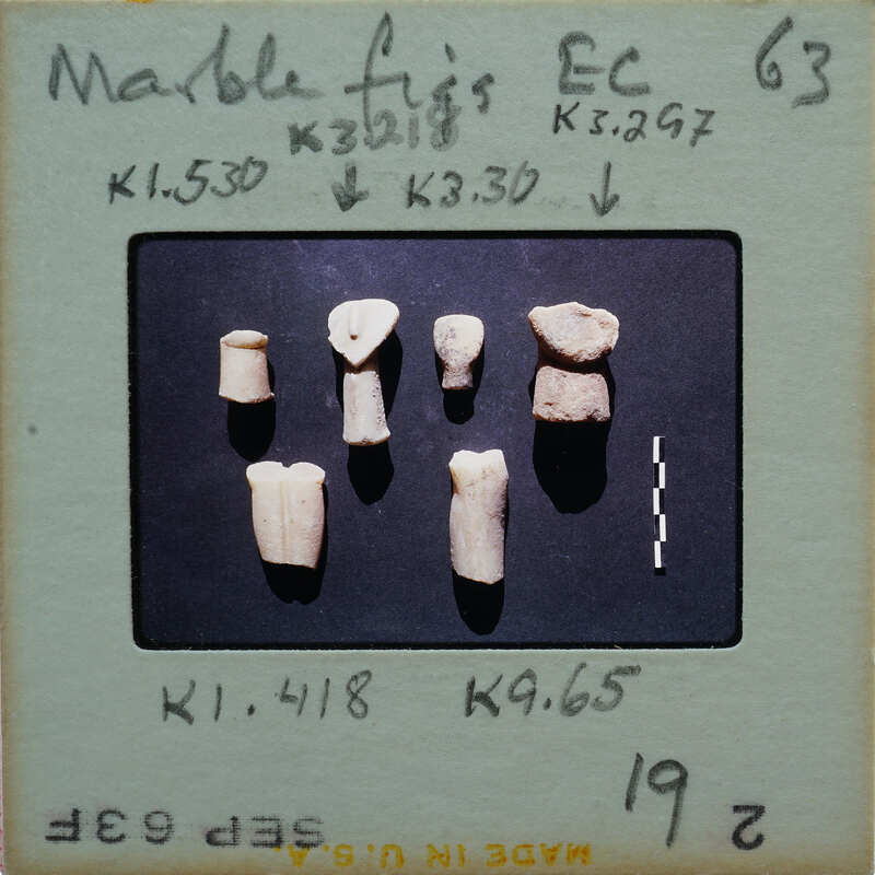 Various marble figurine fragments on a blue background.