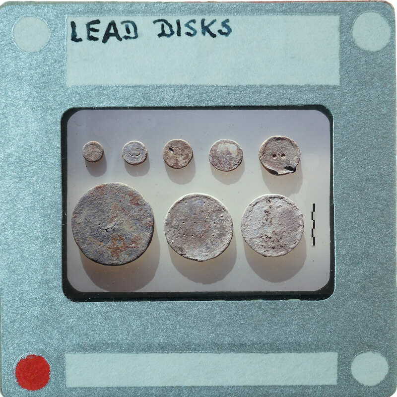 Eight circular metal disks of off-white color identified as lead.