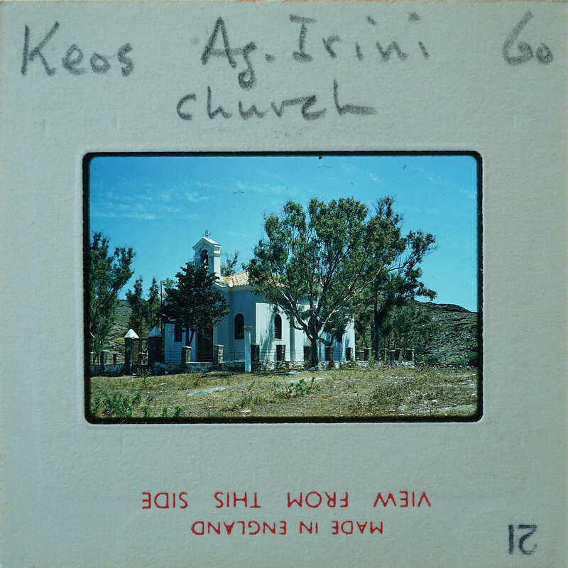 Picture of a church with trees and mountains in the background.