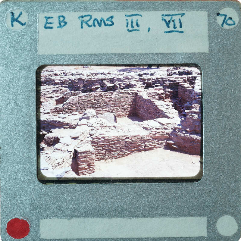 Excavated stone walls in various directions forming rooms.