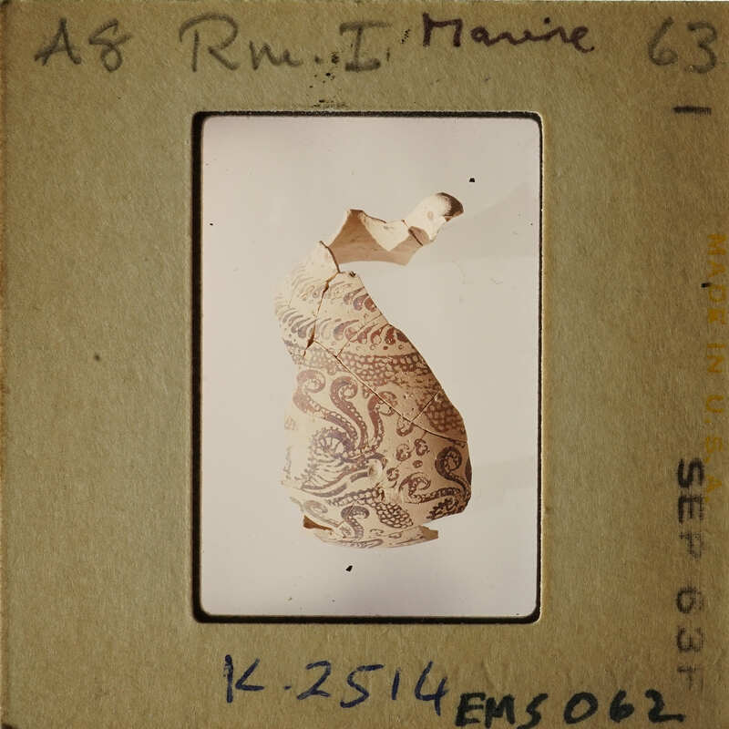 A photograph of an ancient pottery artifact with intricate patterns.