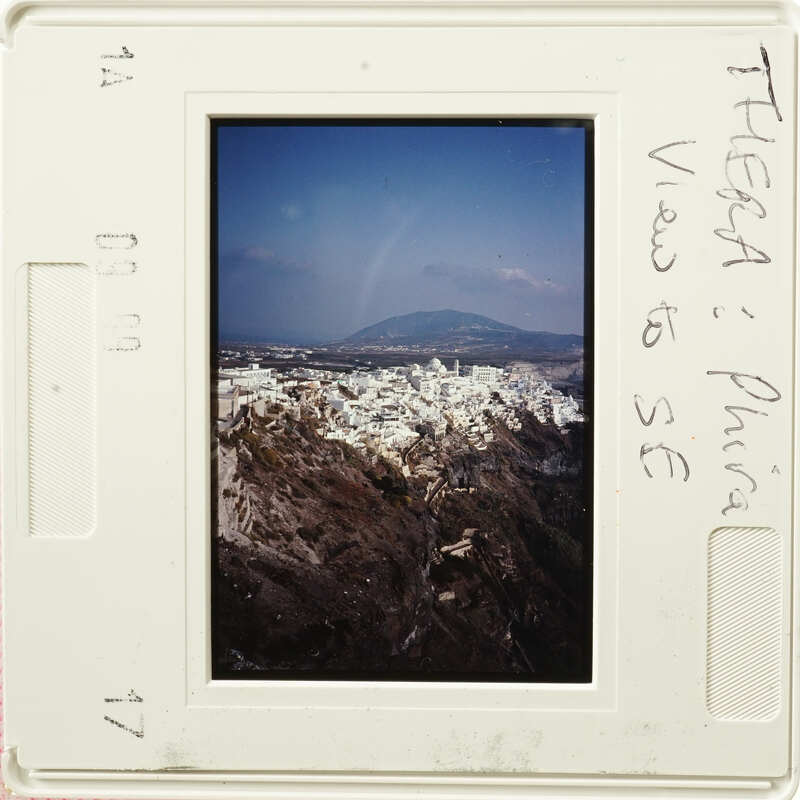 A photograph of an old slide depicting a scenic view with mountains and buildings, labeled "Thessaloniki" and "S.E. Phrygia."