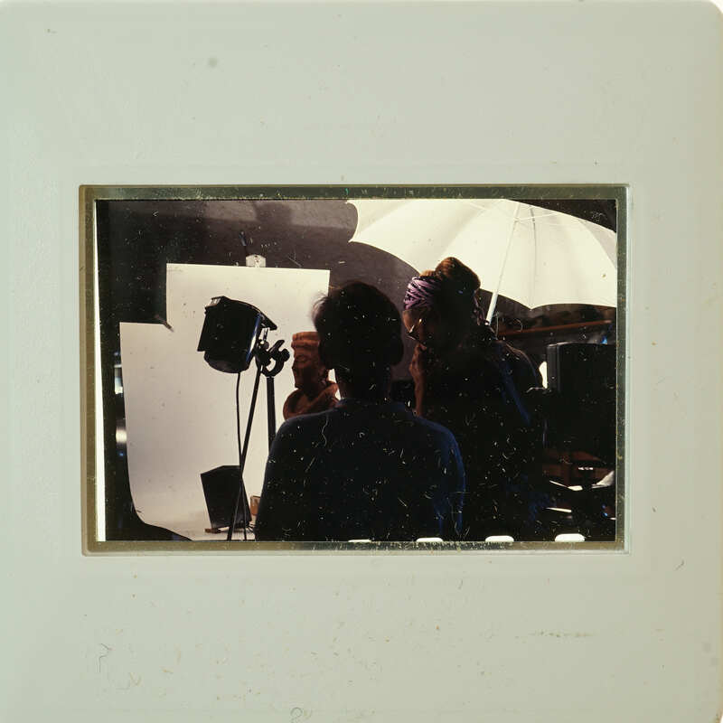 A framed photograph of a man and woman with lighting equipment, possibly taken at an event or photoshoot.