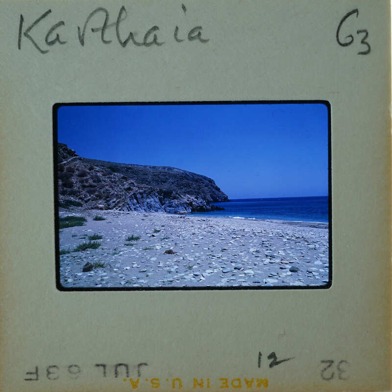 Photo of a rocky beach with the ocean and blue sky, labeled "Kathia" on an old film strip.