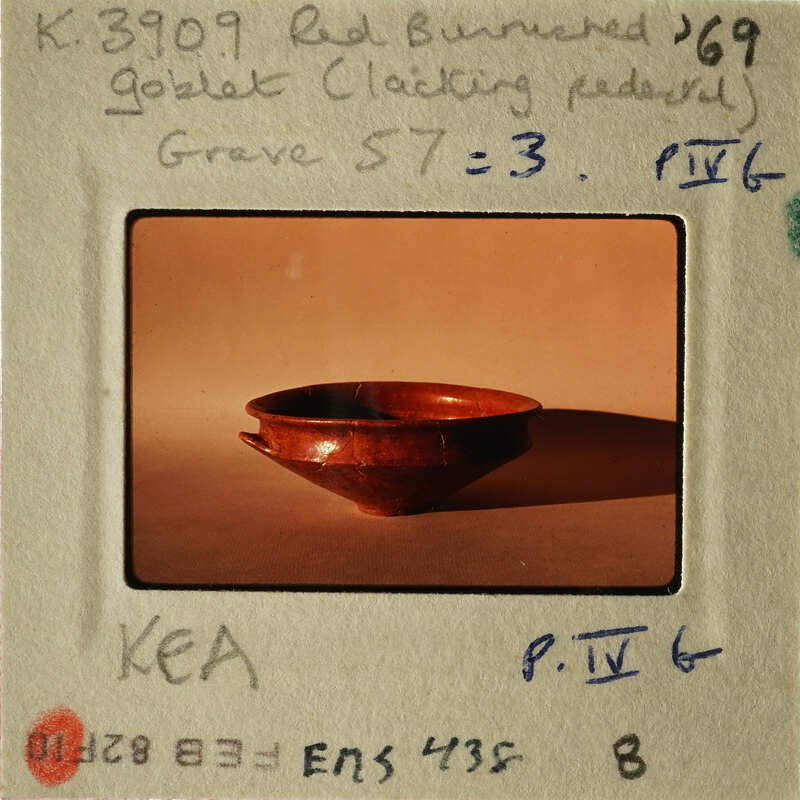 A photograph of an antique ceramic bowl with a label and handwritten notes on its mount.