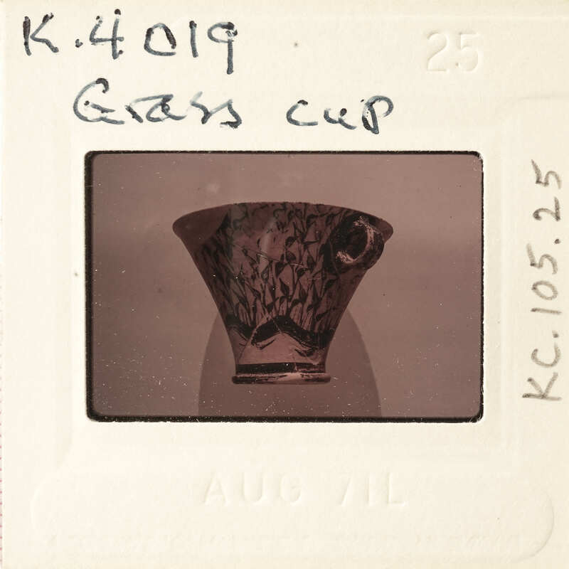 A vintage film strip with a photograph of an antique vase.