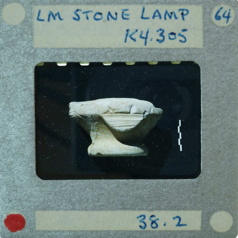 A photograph of a stone lamp with an image of the object on it.