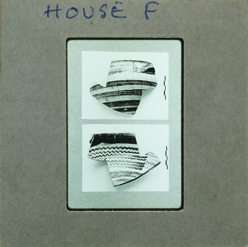 Two sets of partially reassembled pottery showing horizontal wavy lines.