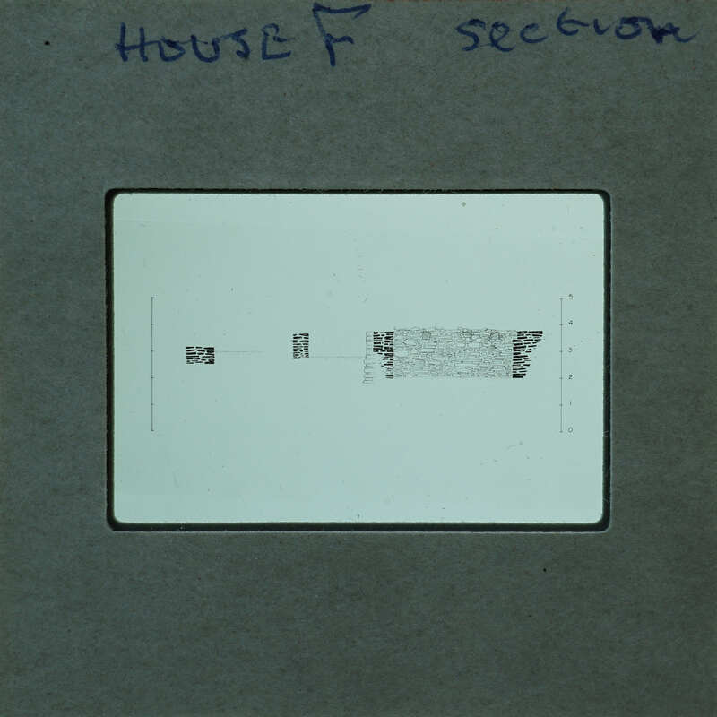 A close-up image of a film strip with handwritten notes and printed text on it.