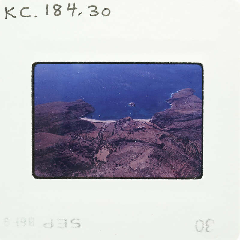 Aerial photograph of a coastal landscape with islands and mountains.