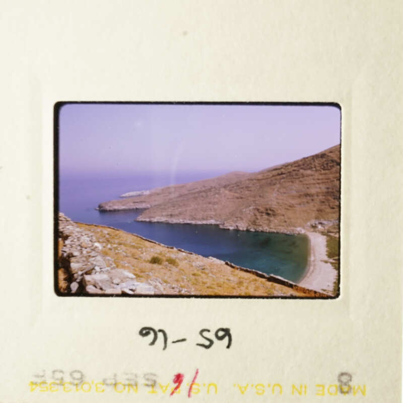 A scenic coastal view with a clear sky and calm water.