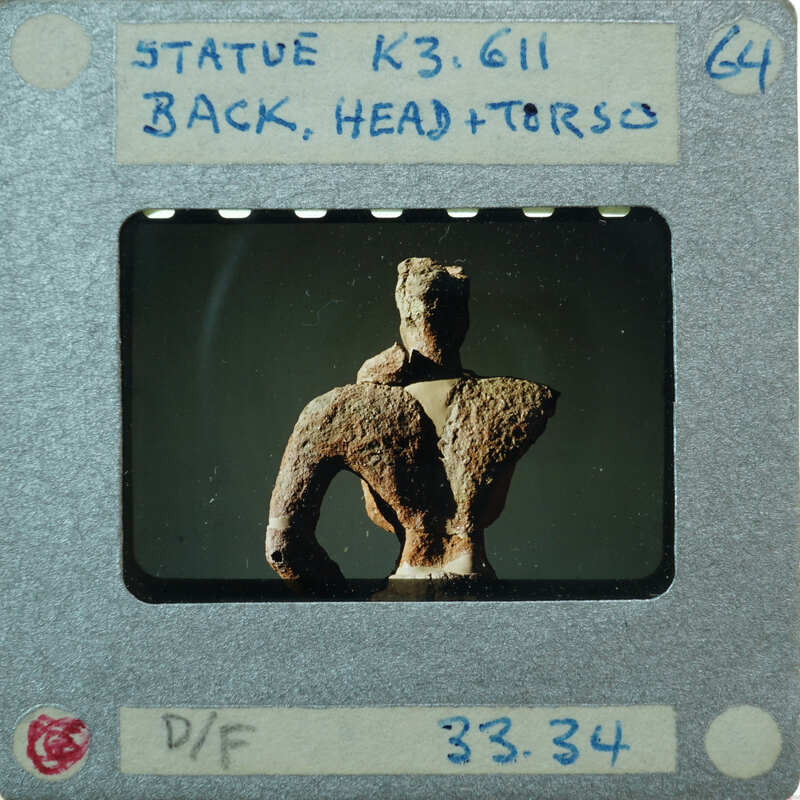 Detail of almost complete terracotta figurine torso from the back minus right arm.