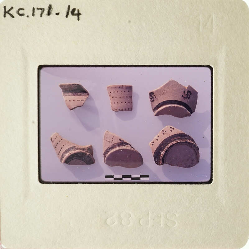 A collection of ancient pottery shards on display.