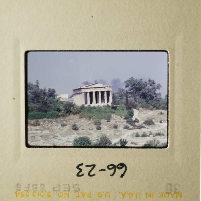 The slide shows an ancient Greek temple with columns, situated on a hill.
