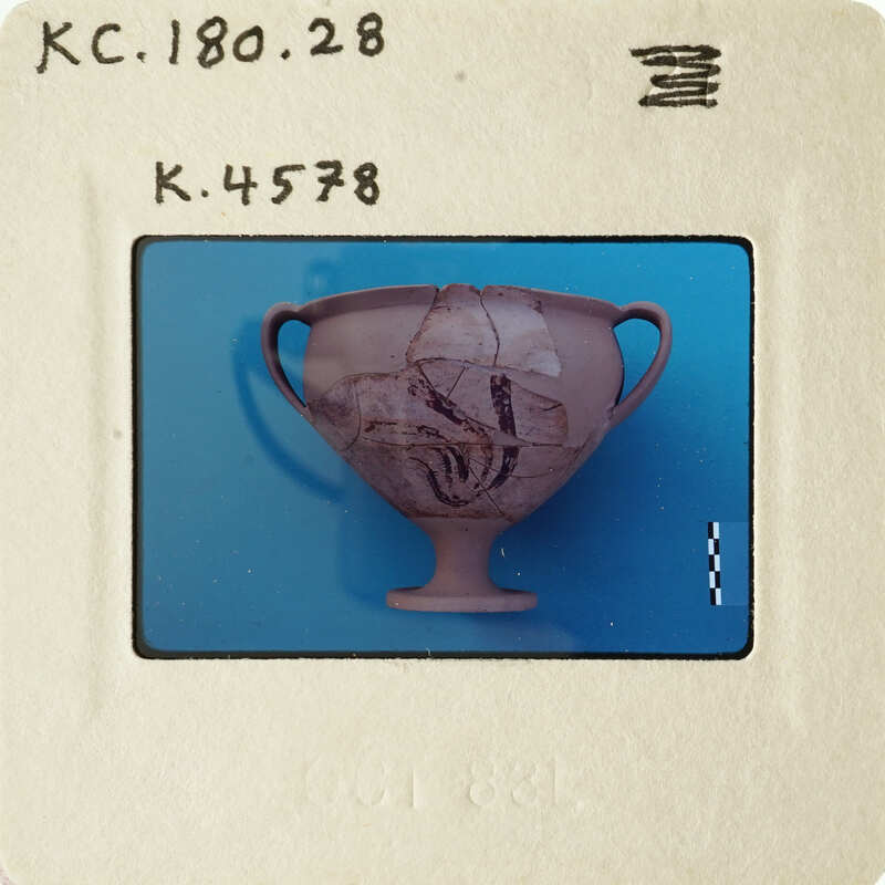 Ancient Greek vase with intricate designs on blue background.