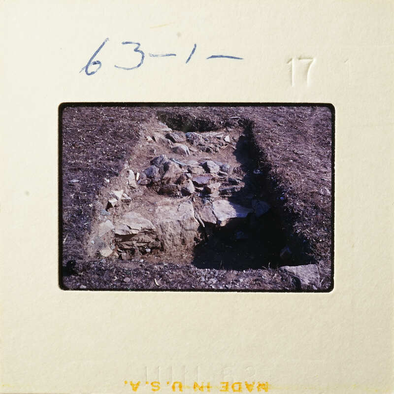 Ancient ruins with visible stone foundations and dirt.