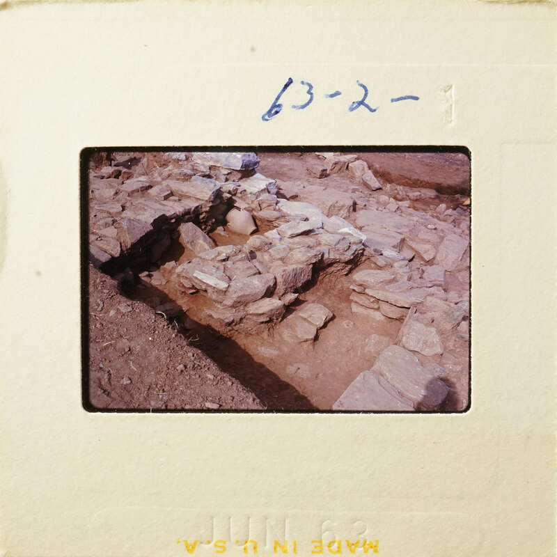 Ancient ruins with stone walls and foundations, partially excavated.