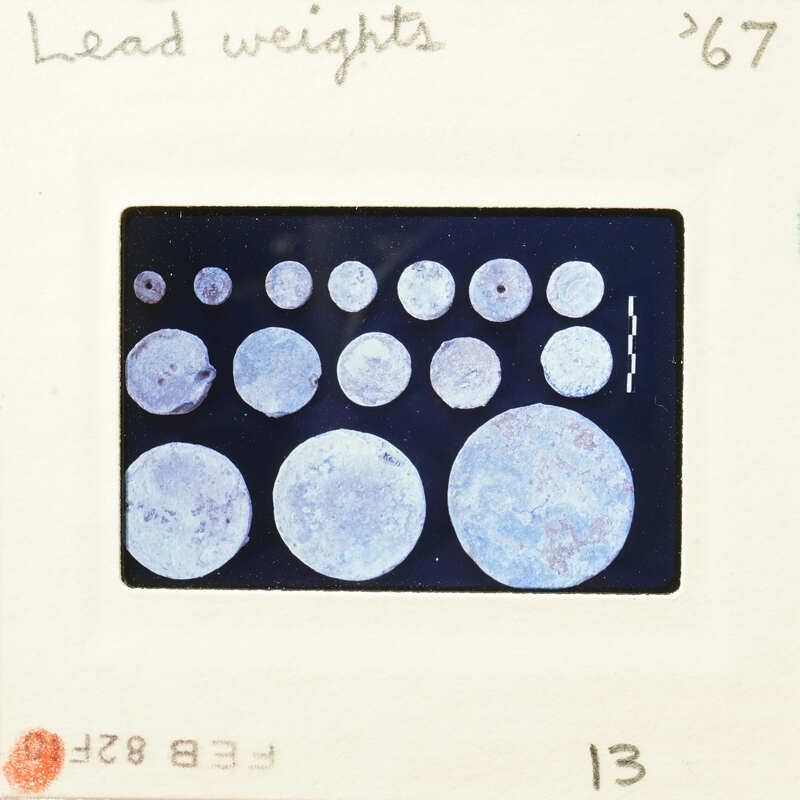 Image of circular objects with varying shades, possibly weights or samples, on a dark background.